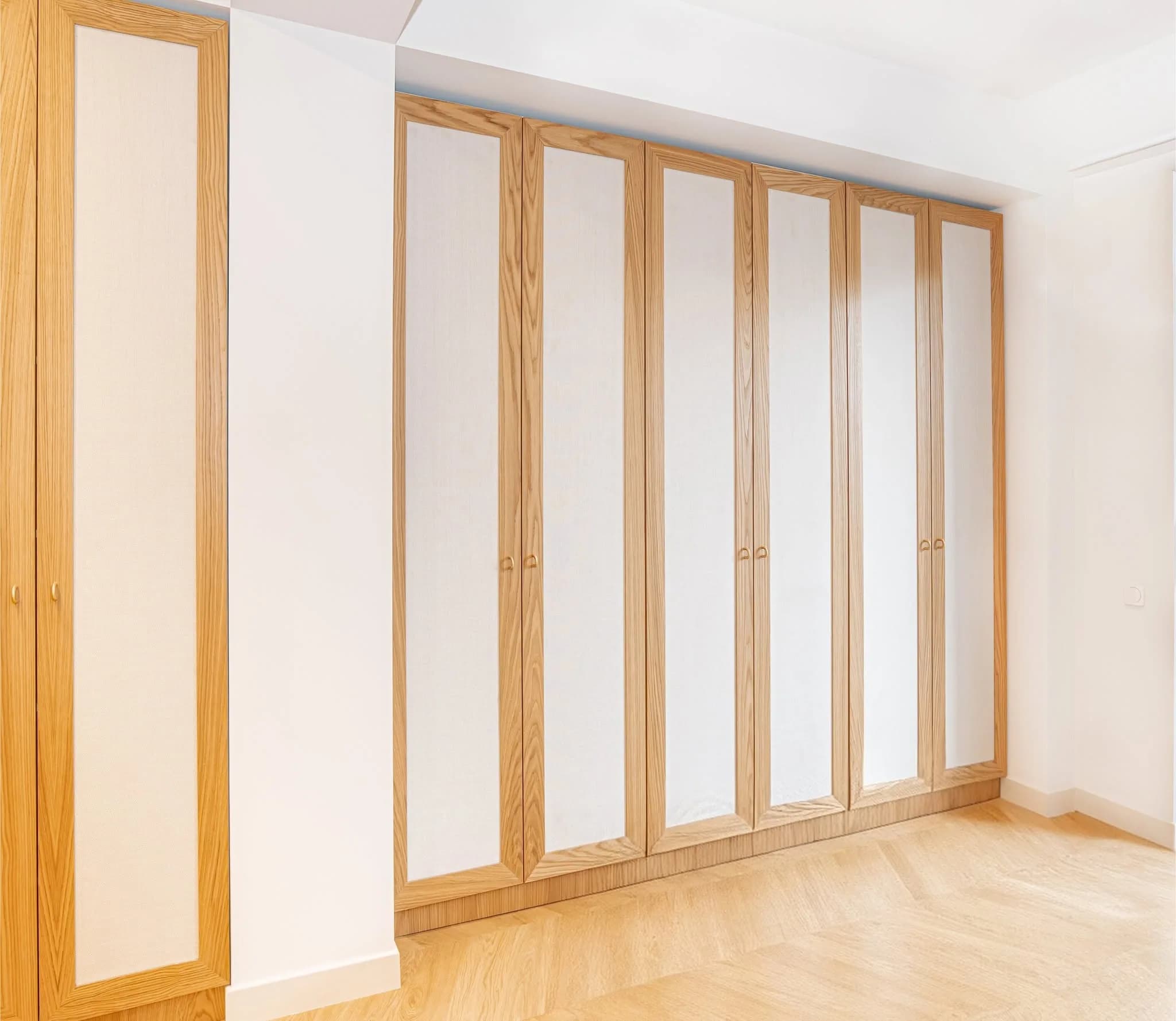 A built-in wardrobe room with wooden detailing