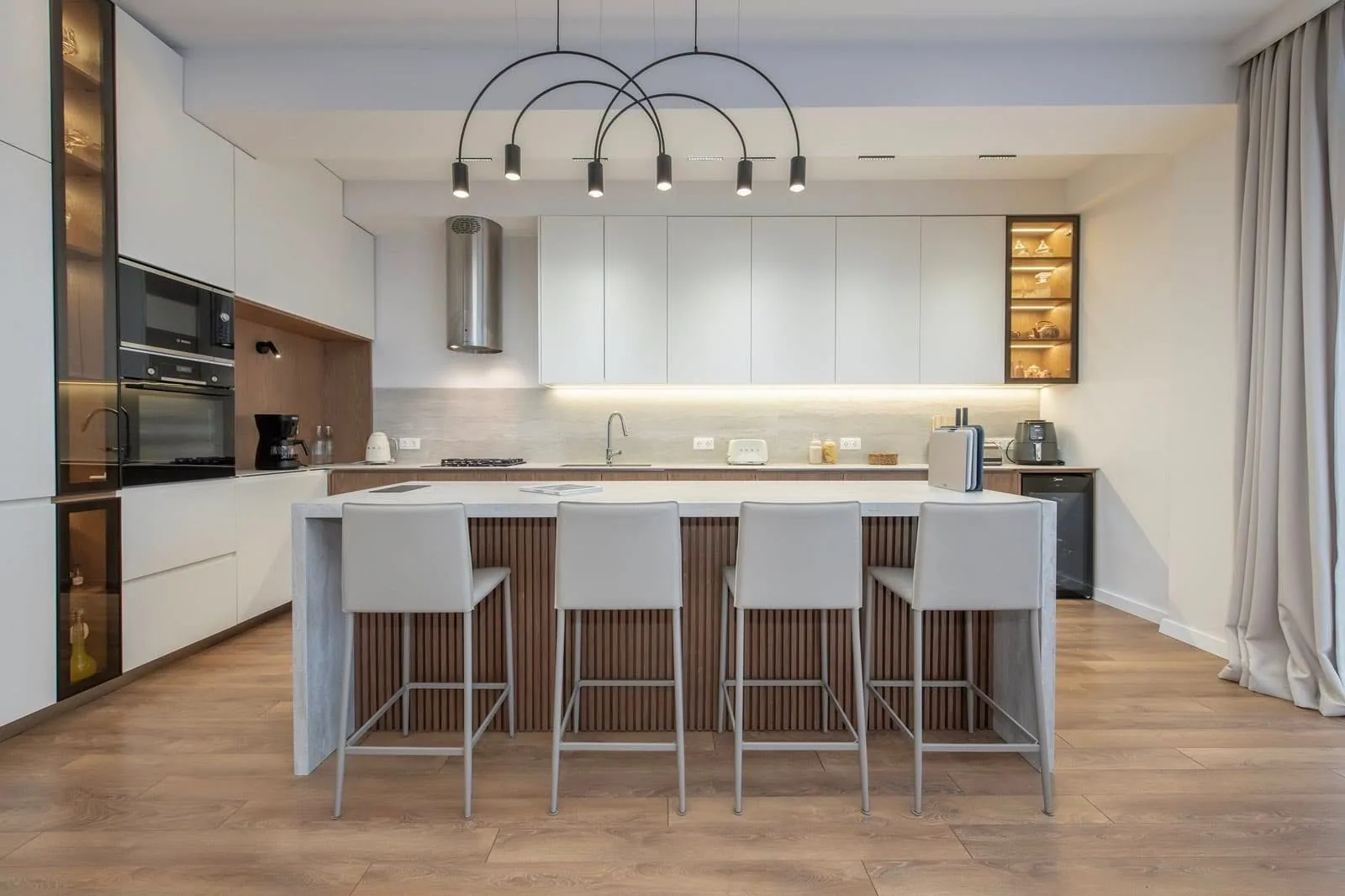 A custom kitchen with dark wood cabinet fronts
